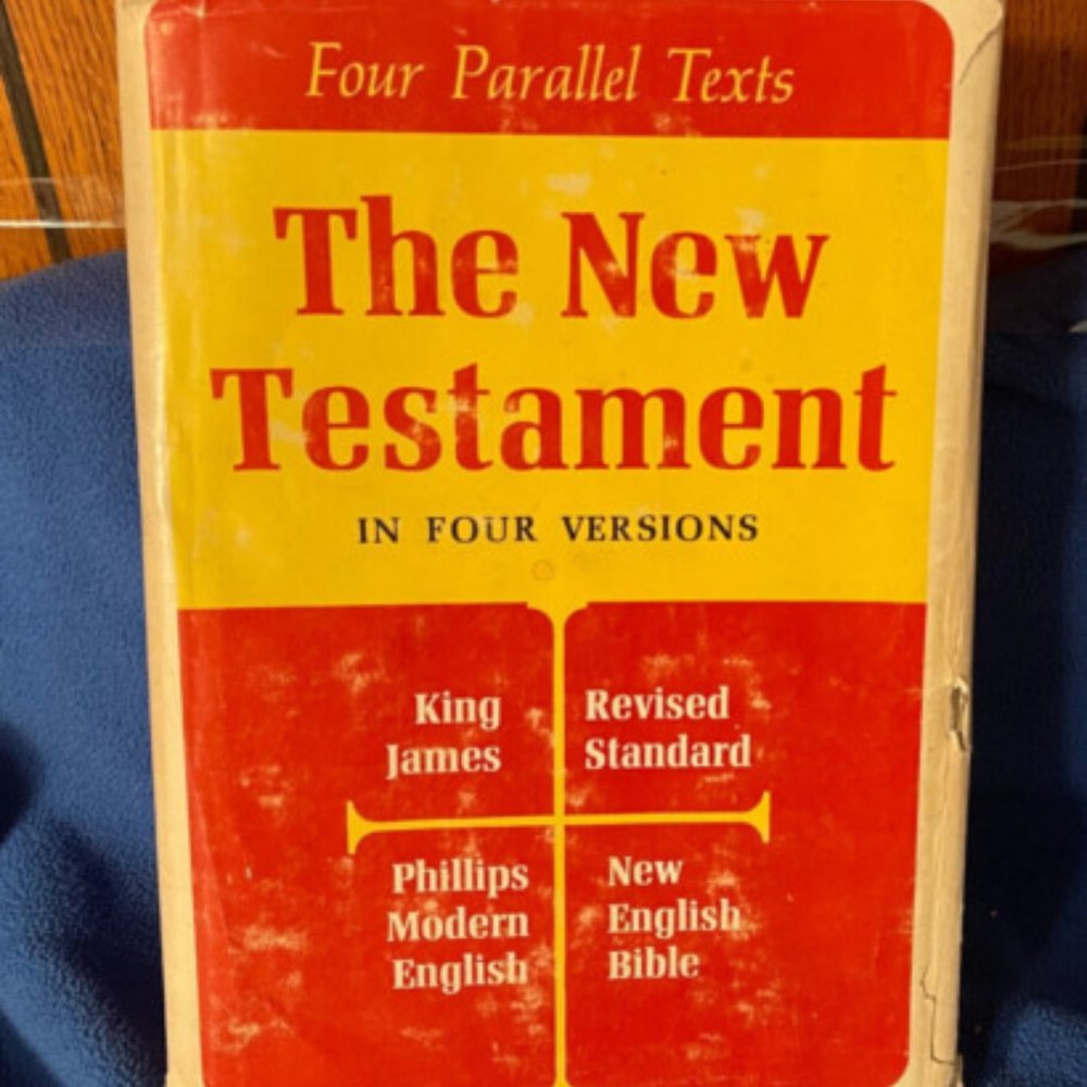 The New Testament In Four Versions - Hard Back With Dust Jacket - Good Condition